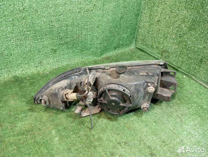 Фара левая Mitsubishi Carisma