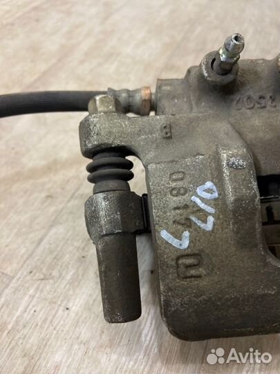 Суппорт тормозной задний левый Mitsubishi Lancer