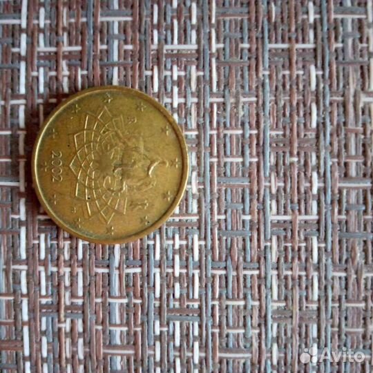 Монета в 50 центов и 25 р