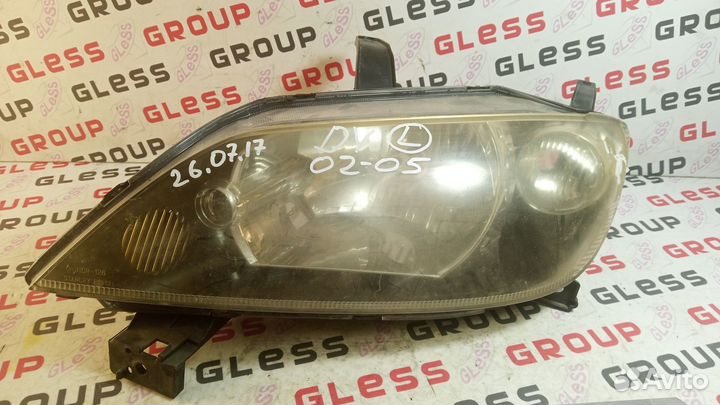 Фара головная DY L не рест б/у (черные очки) Demio