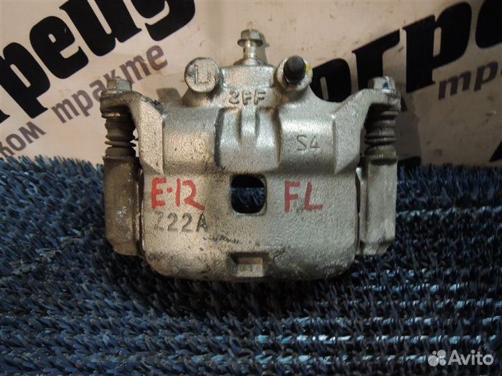 Суппорт тормозной передний левый Nissan Note E12