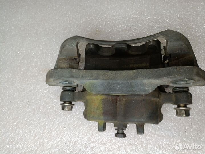 Суппорт тормозной пер. Mitsubishi Grandis chariot