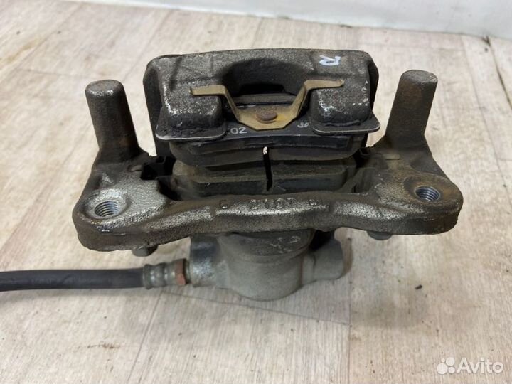 Суппорт тормозной задний левый Mitsubishi Lancer