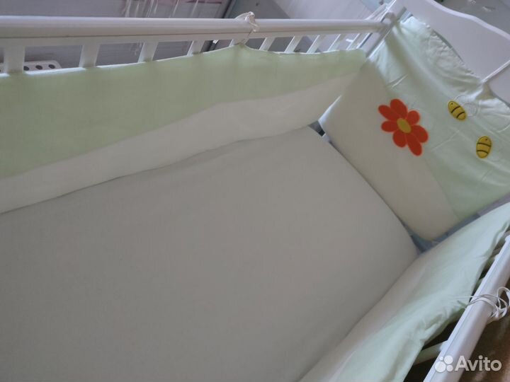 Белая детская кроватка с маятником