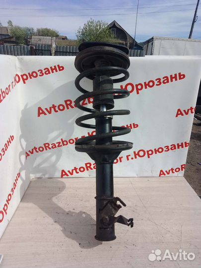 Передний левый амортизатор Mitsubishi Lancer Cedia