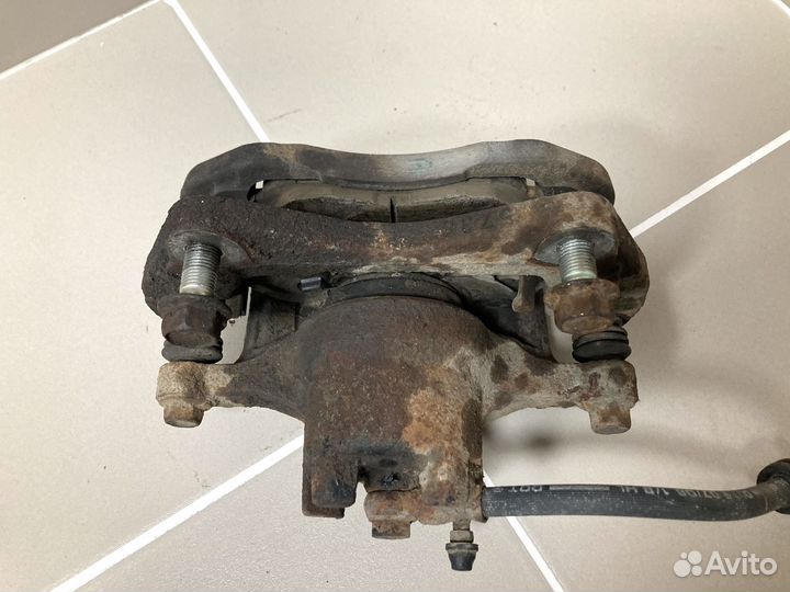 Суппорт тормозной пер левый Mitsubishi Lancer X