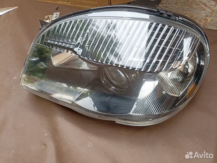 Блок фара Niva Chevrolet левая с чёрным безелем