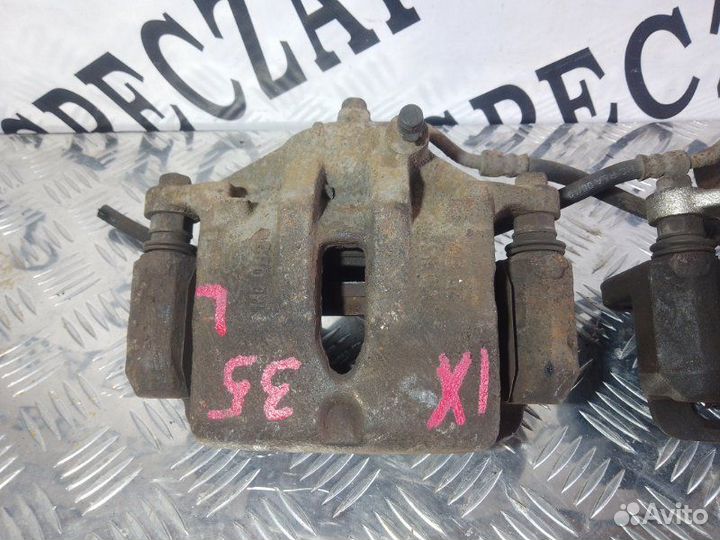 Суппорт тормозной передний левый Hyundai Ix35 I