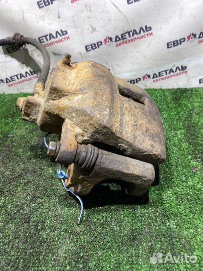 Суппорт тормозной передний левый Nissan Almera N16