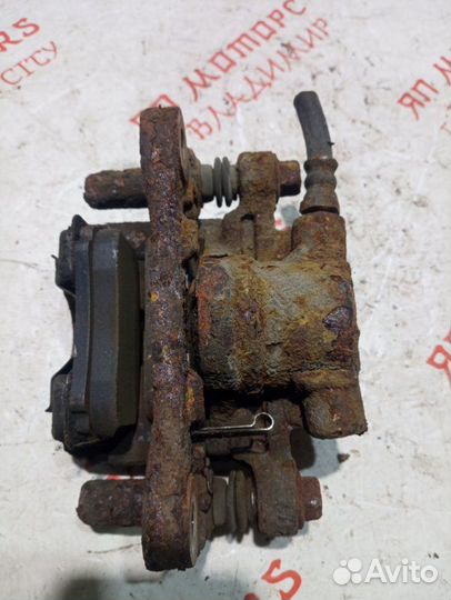 Суппорт тормозной задний Mitsubishi Lancer 10 CY4A