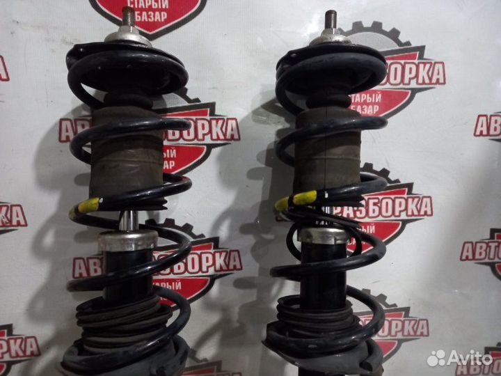 Стойка передняя Nissan March K13 HR12DE 2011