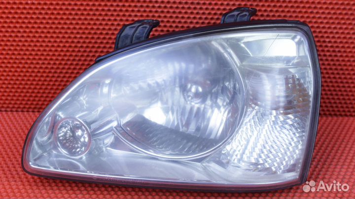 Фара левая Kia Carens FJ G4GC 0K2FA-51020L