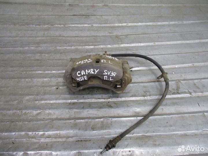 Суппорт тормозной передний левый Toyota Camry SV30