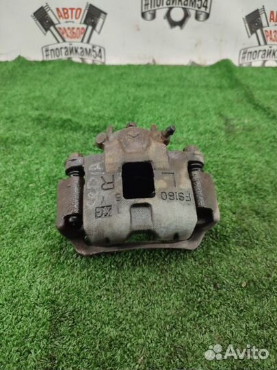 Суппорт передний левый Mitsubishi Lancer Cedia