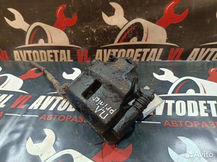 Суппорт тормозной передний левый Nissan Primera