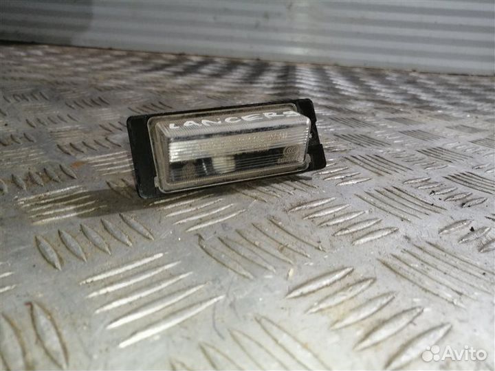 Фонарь подсветки номера задний левый Mitsubishi